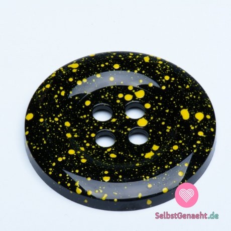 Mega großer schwarzer Knopf mit gelben Spritzern