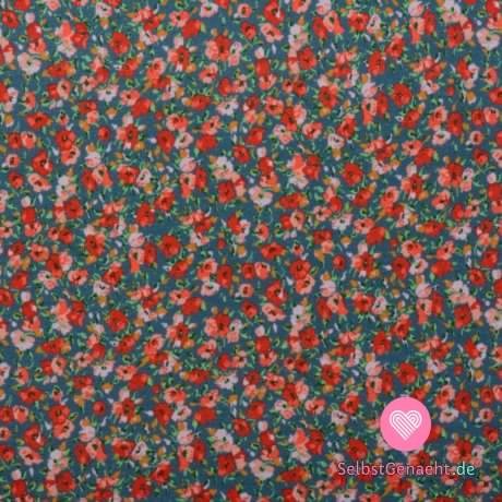 Viskose-Strickdruck mit winzigen roten und rosa Blumen auf Blue Jeans