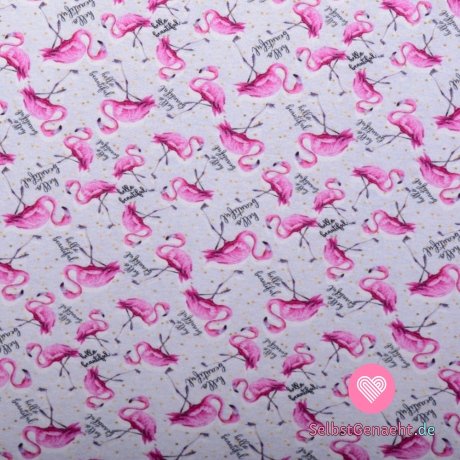 Strickdruck Flamingos im Text auf grauem Hintergrund mit Tupfen